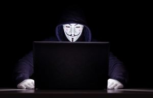 hacker behind computer